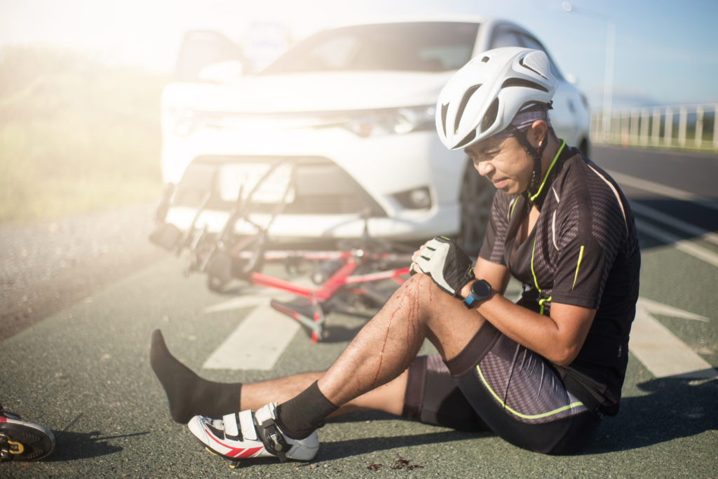 Asia cyclist injured on the street bike after collision accident car and bike.